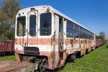 rusty old, whit and read railway carriage